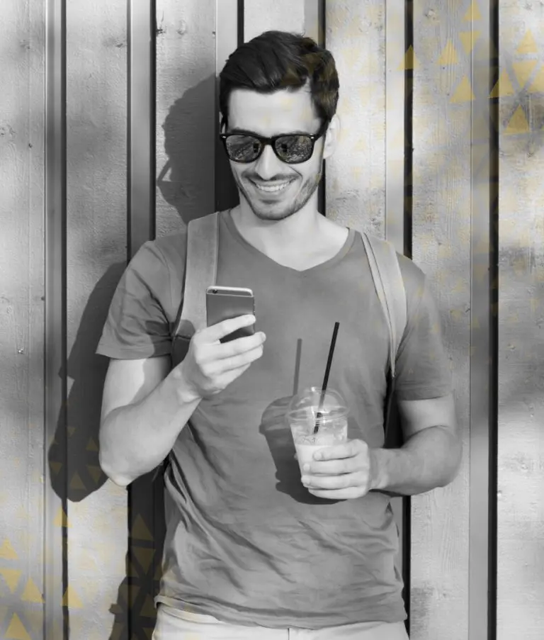 man smiling while browsing on phone